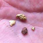 Hydrochloric acid is a good way of cleaning gold nuggets coated in ironstone